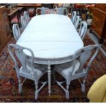 A pale grey chalk-painted Swedish Gustavian style double d-end dining table, raised on six turned