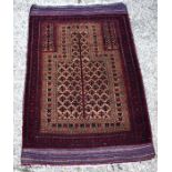 An Afghan Baluch prayer rug, circa 1920, the central reserve with repeating star like motif with