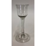 An 18th century cordial glass with ogee bowl, plain stem, fold over foot and rough pontil, 14.7 cm