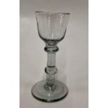An 18th century cordial glass, ogee bowl, collar, flattened knop, conical base, rough pontil, 13.5