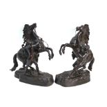 A pair of brown patinated bronze Marley horses after Nicolas Coustou, 35 cm high