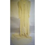 An early 1940s bespoke ivory embossed crepe wedding dress (the 'Cloque' material imported from