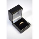 An early 20th century 18ct yellow gold ring set with five old cut graduated diamonds, graduating
