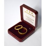 A 22ct yellow gold wedding band, size I to/w another 22ct yellow gold wedding band with engraved