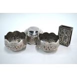 A set of three Burmese, or other Asian, white metal bowls, 6 cm diameter; together with a matchbox