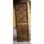 A pair of Chinese provincial elm doors/screen panels, each with geometric reticulated upper panels