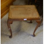 A mahogany cane seated stool