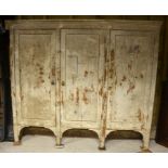 19th century painted pine triple cupboard with panelled doors enclosing fitted shelves