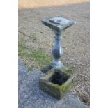 A weathered cast stonecrete pedestal sundial base