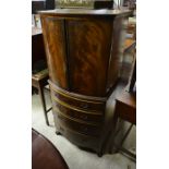 Mahogany bowfront cabinet on chest with a pair of cupboard doors over four graduating drawers