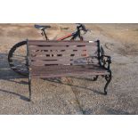 A cast iron and stained teak two seater garden bench