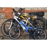 Muddyfox Downtown bicycle with pannier, Land Rover hardtail bike, two other mountain bikes and