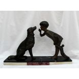 An Art Deco style spelter and marble figure group of a young girl with a doll whispering to a