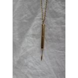 A 9ct gold propelling toothpick, approximately 6 grams, on an 18ct yellow gold long chain,