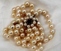 A choker comprising a double row of regular pearls to a 9ct gold,