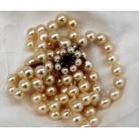 A choker comprising a double row of regular pearls to a 9ct gold,