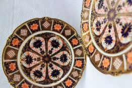 A pair of Royal Crown Derby 8706 Imari palette porcelain plates, with a scalloped edge in reds,