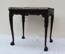 A George III style mahogany silver table with a spindle gallery,