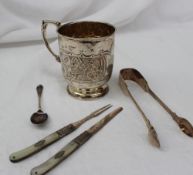 A Victorian silver christening mug, with scroll decoration on a pedestal foot,