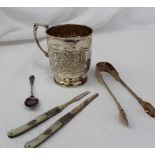 A Victorian silver christening mug, with scroll decoration on a pedestal foot,