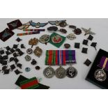 Two World War II medals including The Defence medal and The War medals together with a replica