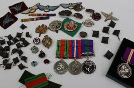Two World War II medals including The Defence medal and The War medals together with a replica