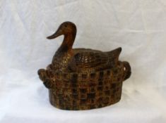 A pottery duck and basket terrine, in mottled browns,
