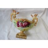 A Royal Worcester twin-handled pedestal vase of oval form with dragon handles painted with wild