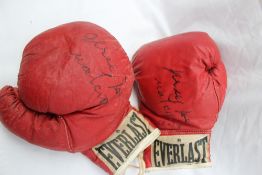 Jersey Joe Walcott - A pair of signed Everlast boxing gloves dated 8-1-83,