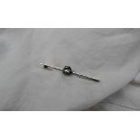 A diamond bar brooch set with a round old cut diamond, approximately 1.