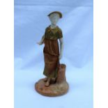 A Royal Worcester porcelain figure of a maiden in a green and gilt highlighted gown,