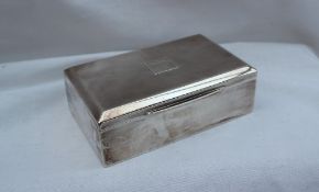 A George V silver cigarette box of rectangular form, with a central initialled cartouche,