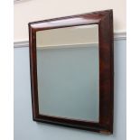 An 18th century walnut wall mirror with a cushion frame, of rectangular form,