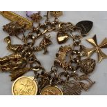 A 9ct yellow gold charm bracelet, set with numerous charms including a chalet, chariot,