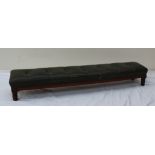 A Victorian kneeling stool with a button upholstered cushion on four ring turned legs,
