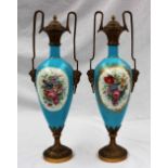 A pair of Sevres style porcelain and ormolu mounted twin handled vases and covers,