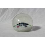 A 20th century glass paperweight, with floral canes and a swirling white decoration,