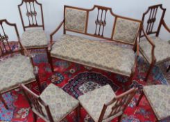 An Edwardian mahogany salon suite comprising two seater settee,