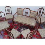 An Edwardian mahogany salon suite comprising two seater settee,