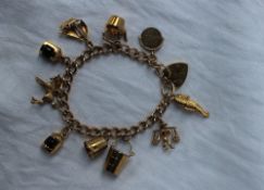 A 9ct gold charm bracelet, set with numerous charms including a sea horse, bucket, thimble,