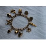 A 9ct gold charm bracelet, set with numerous charms including a sea horse, bucket, thimble,