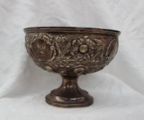 A late Victorian Silver pedestal rose bowl, embossed with flower heads and leaves,