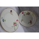 A pair of Swansea porcelain plates, painted with sprays and individual flowers to a gilt rim,