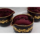 A set of three 19th century amethyst glass and gilt highlighted glass coolers,