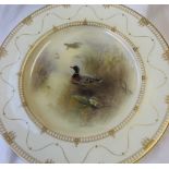 A Royal Worcester porcelain plate transfer and infil decorated to the centre with wild ducks,