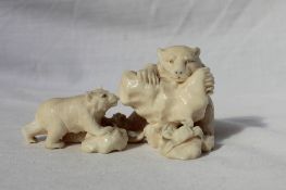 A Japanese carved ivory figure group of two bear cubs, a salmon and crab,