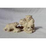 A Japanese carved ivory figure group of two bear cubs, a salmon and crab,