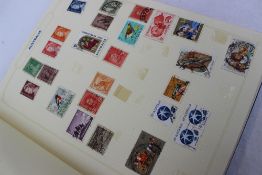 A simplex medium stamp album containing World Stamps,