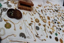 A large collection of costume jewellery, including yellow metal necklaces, bead necklaces,