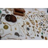 A large collection of costume jewellery, including yellow metal necklaces, bead necklaces,